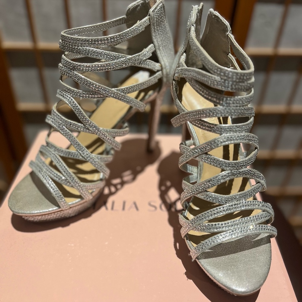 Silver metallic open toe shoe sandal.